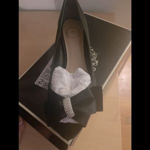 Black satin dress shoes with stones.